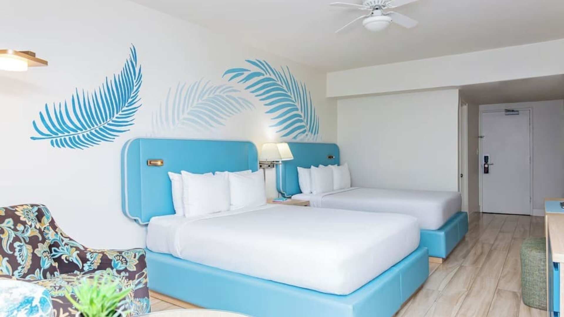 Guest room with two double beds and modern furnishings at Sherry Frontenac Oceanfront Hotel.