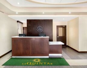 Hotel reception desk at La Quinta Inn & Suites By Wyndham Oshawa.