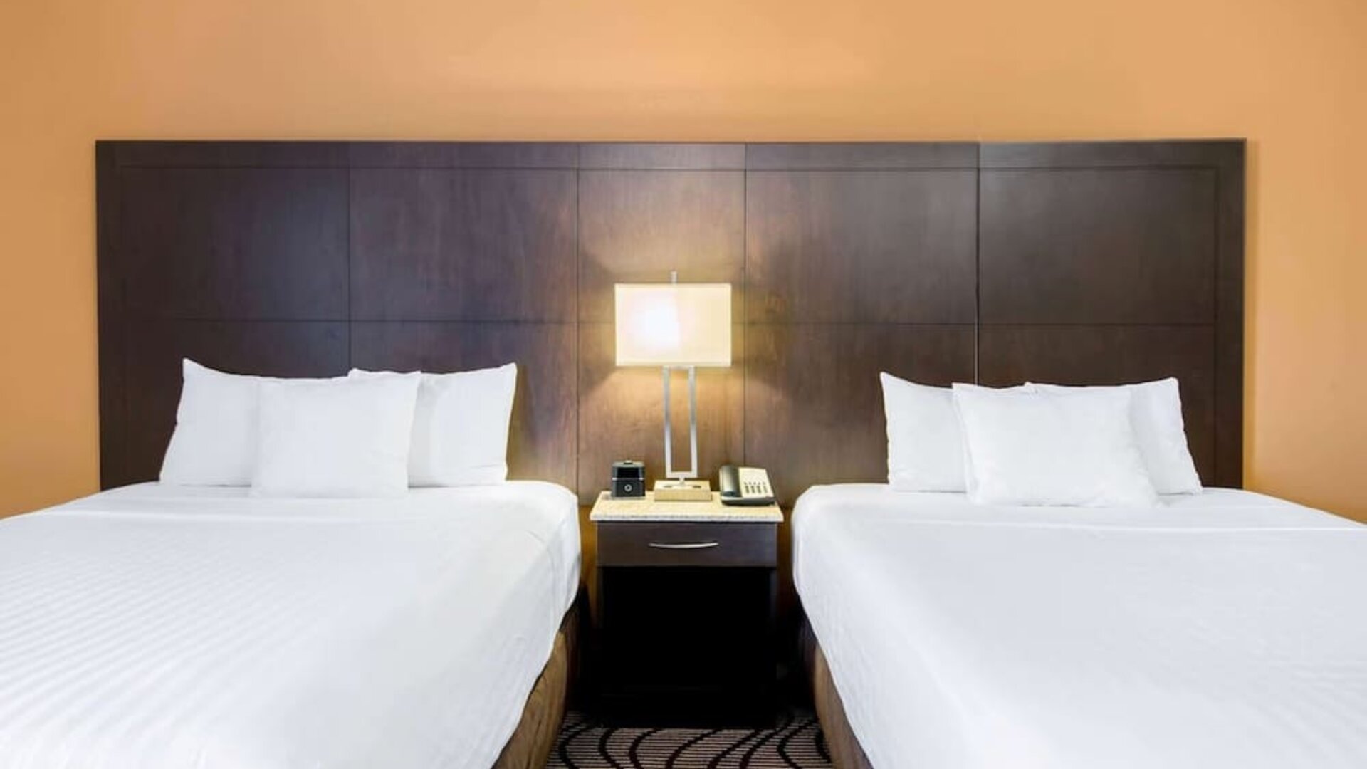 Guest room with two queen beds and work area at La Quinta Inn & Suites By Wyndham Oshawa.