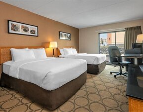 Guest room with two queen beds and a work desk at Comfort Inn Prince Albert.