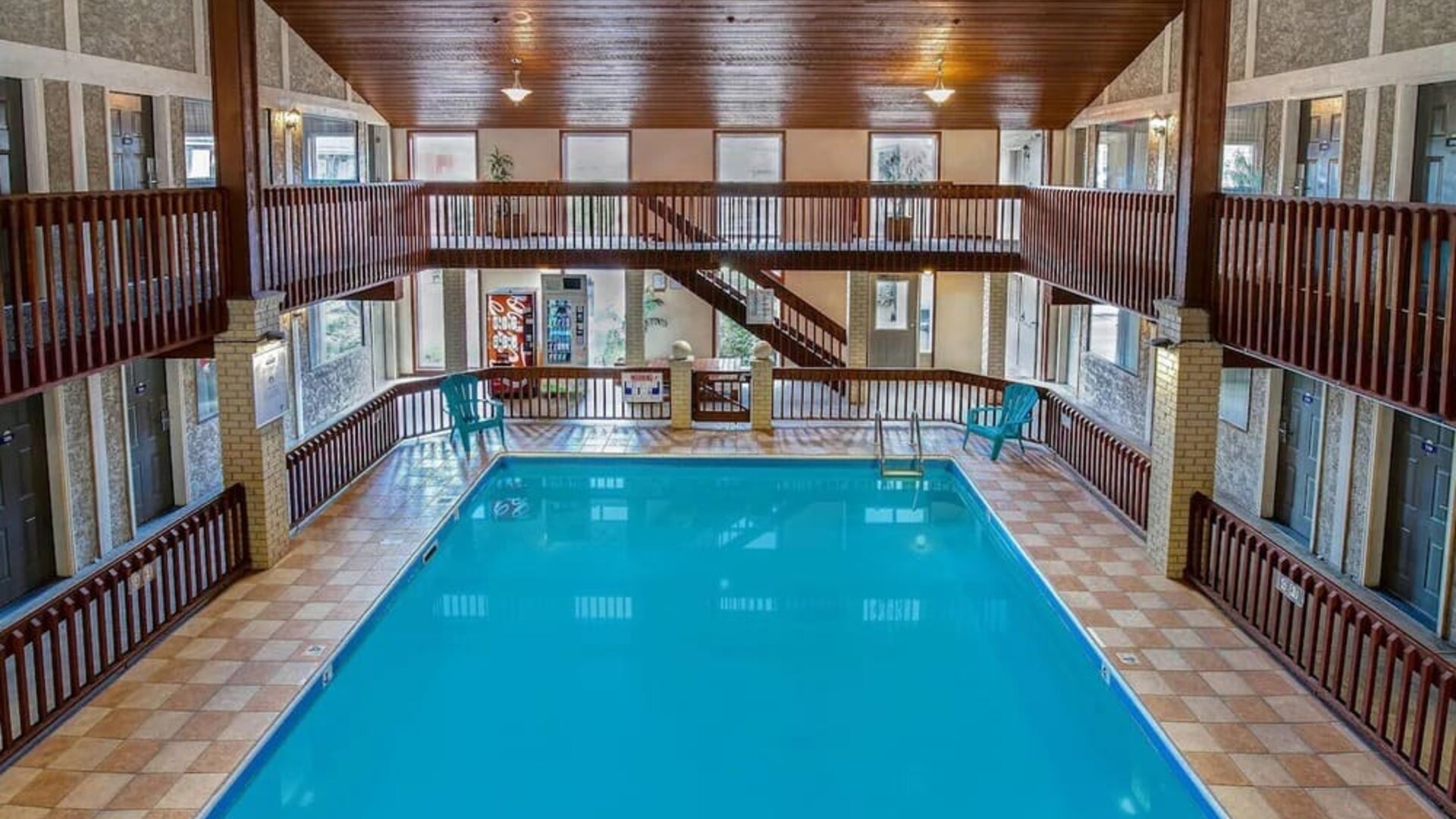 Spacious indoor swimming pool with atrium seating at Days Inn Vernon.