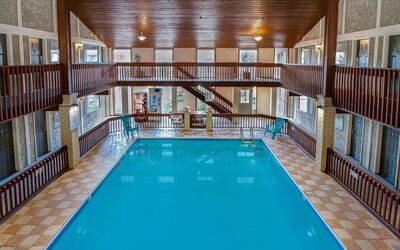 Spacious indoor swimming pool with atrium seating at Days Inn Vernon.