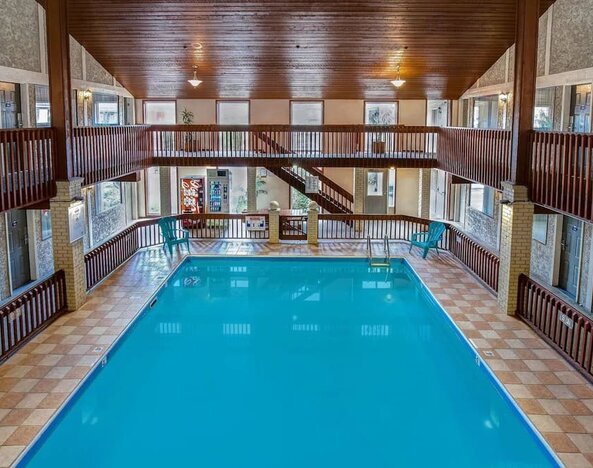 Spacious indoor swimming pool with atrium seating at Days Inn Vernon.