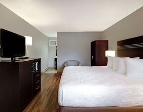 Guest room with a king bed and TV at Days Inn Vernon.