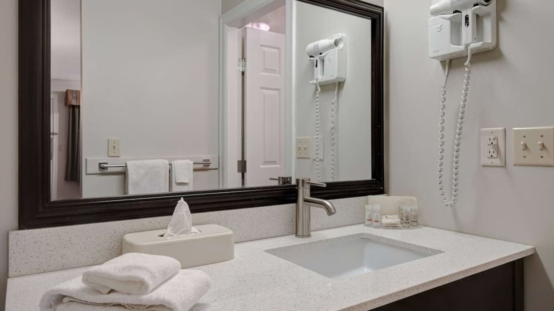 Guest bathroom vanity with sink and amenities at Days Inn Vernon.