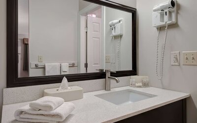 Guest bathroom vanity with sink and amenities at Days Inn Vernon.