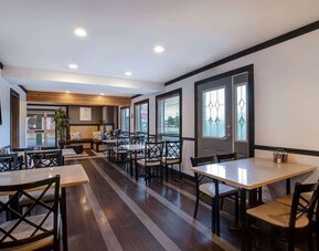 Breakfast dining area with tables and seating at Days Inn Vernon.