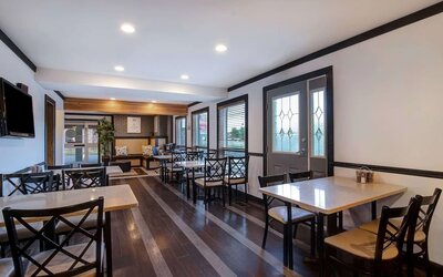 Breakfast dining area with tables and seating at Days Inn Vernon.