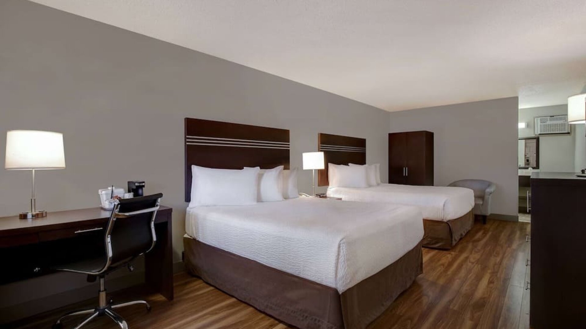 Guest room with two queen beds and work desk at Days Inn Vernon.