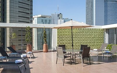 Rooftop terrace with sun loungers, outdoor seating and surrounding city skyline views at Hotel Casa Blanca.