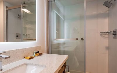 Day use guest bathroom with shower and toiletries at Executive Residency By Best Western.