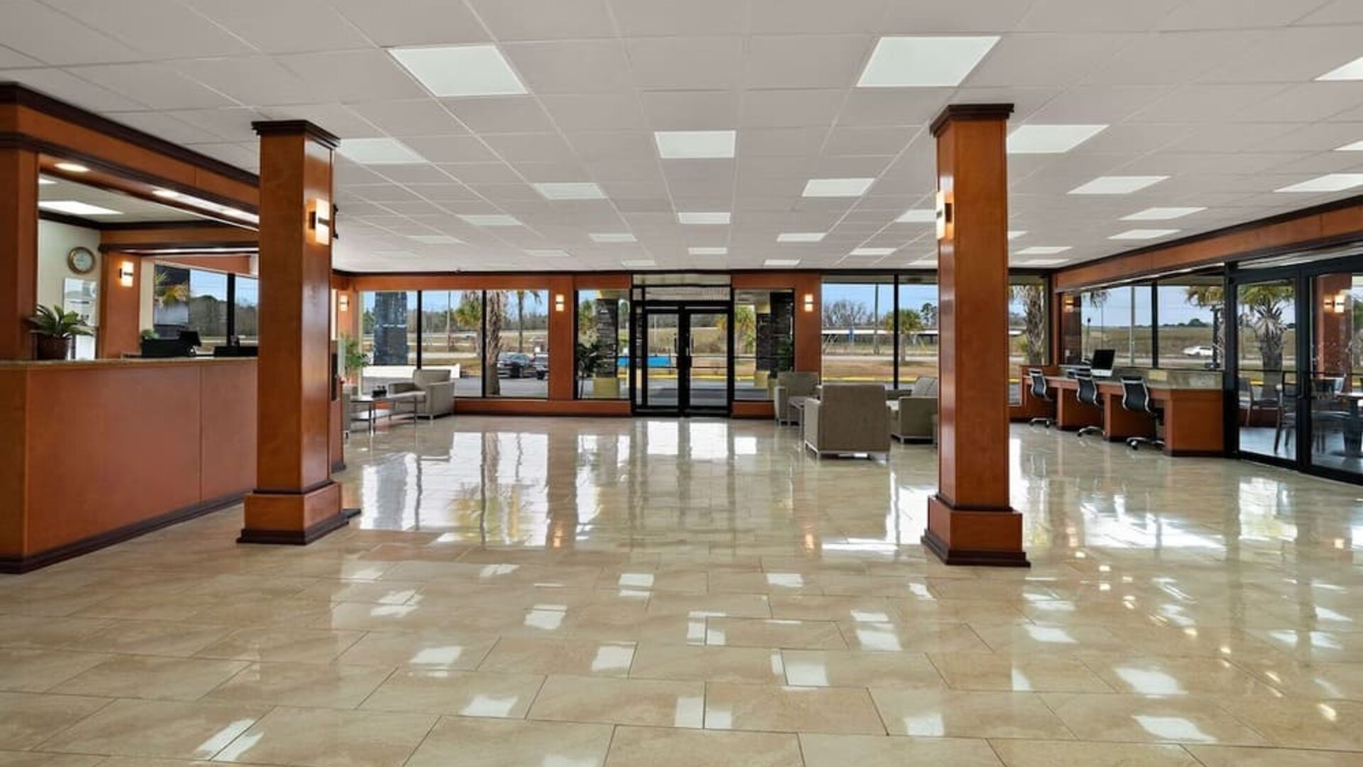 Spacious hotel lobby with polished tile floors, seating areas and large glass entrance doors at Quality Inn Yemassee - Point South I-95.