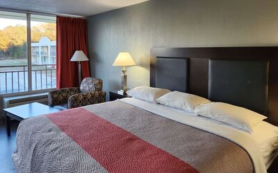 King guest room with large window, seating area and courtyard views at Econo Lodge Yemassee.