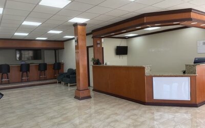 Reception desk with polished tile flooring, guest seating and check-in counter at Econo Lodge Yemassee.