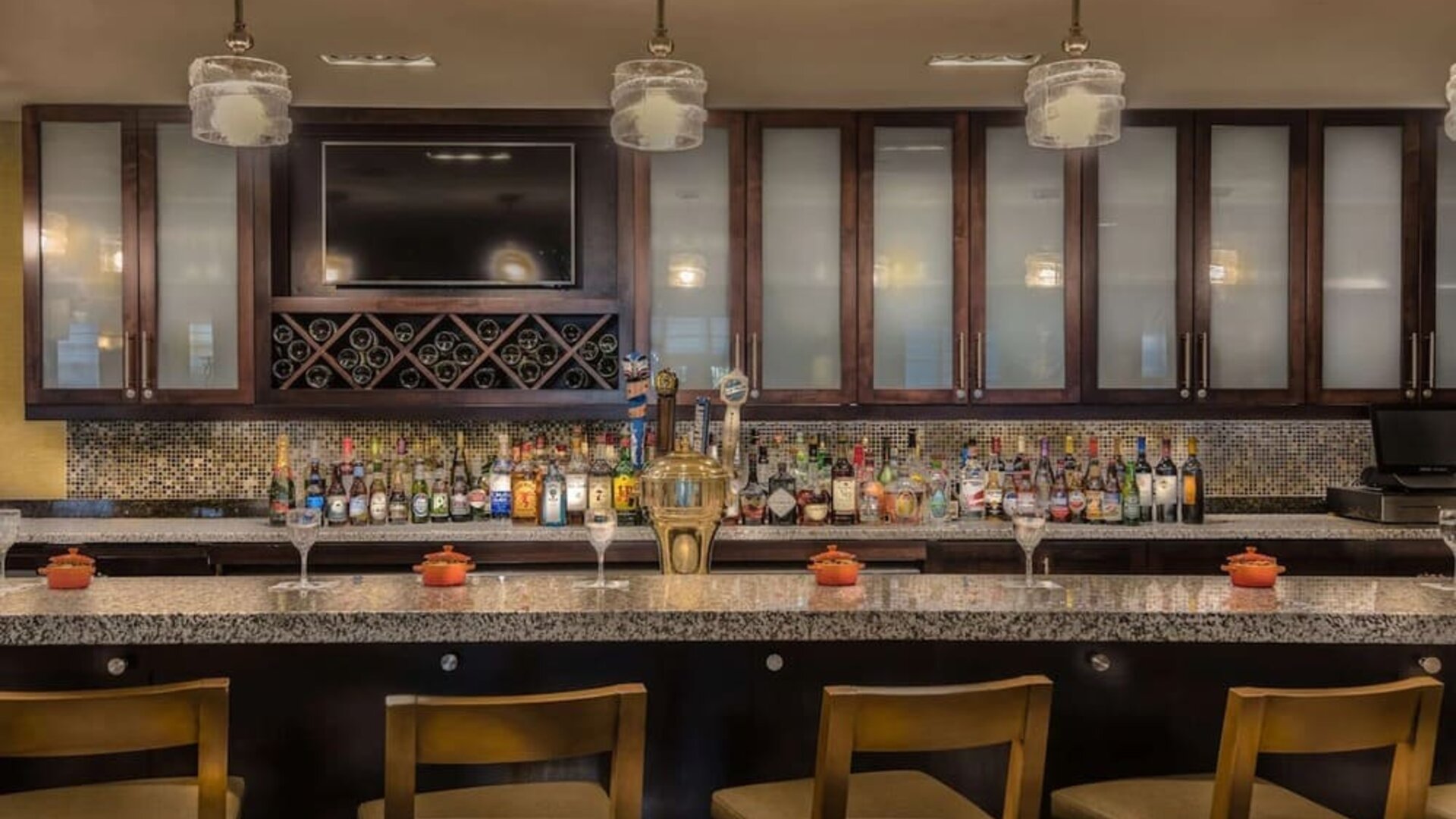 Contemporary hotel bar serving cocktails, beer, wine, and spirits with comfortable seating in a stylish atmosphere.