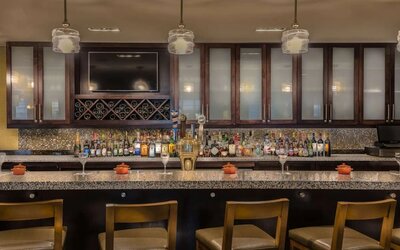 Contemporary hotel bar serving cocktails, beer, wine, and spirits with comfortable seating in a stylish atmosphere.