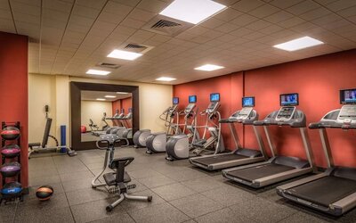 On-site fitness center featuring treadmills, elliptical machines, stationary bike, free weights, and exercise equipment.