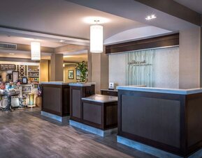 Modern hotel reception area with front desk, lobby market, and welcoming check-in space for arriving guests.