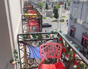Private balcony with colorful seating and city views at Dolce Vita Rooms & Breakfast.