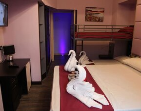 Family room with one double bed, bunk beds and complimentary wine at Dolce Vita Rooms & Breakfast.