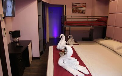 Family room with one double bed, bunk beds and complimentary wine at Dolce Vita Rooms & Breakfast.