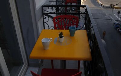 Private balcony with table, seating and views of the surrounding city at Dolce Vita Rooms & Breakfast.