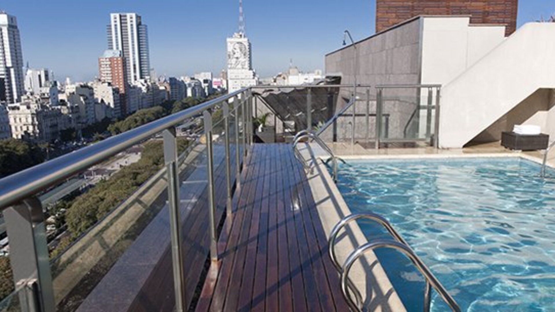 Rooftop outdoor swimming pool with panoramic city views, sun deck and lounge area at NH Buenos Aires 9 De Julio.