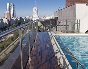 Rooftop outdoor swimming pool with panoramic city views, sun deck and lounge area at NH Buenos Aires 9 De Julio.