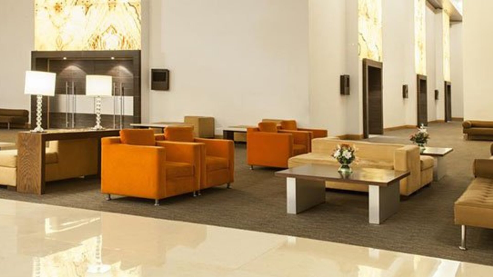 Modern lobby lounge with comfortable seating, high ceilings and contemporary décor at NH Collection Mexico City Airport T2.