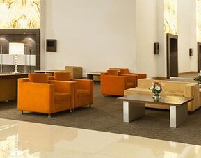 Modern lobby lounge with comfortable seating, high ceilings and contemporary décor at NH Collection Mexico City Airport T2.