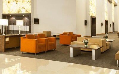 Modern lobby lounge with comfortable seating, high ceilings and contemporary décor at NH Collection Mexico City Airport T2.