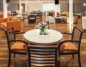 Stylish restaurant and lounge area with contemporary seating, dining tables and relaxed atmosphere at NH Collection Mexico City Airport T2.
