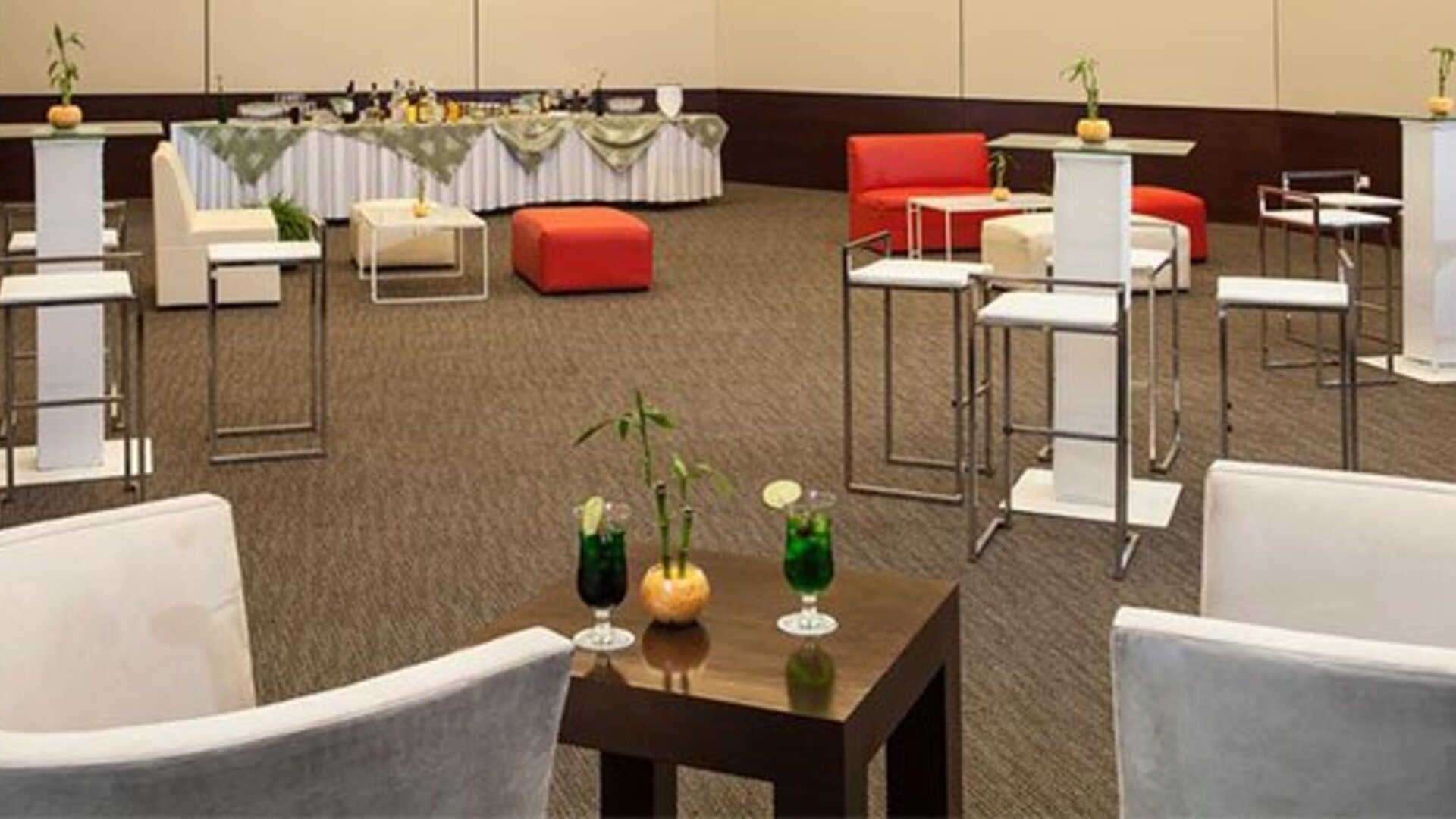 Elegant event lounge with cocktail tables, comfortable seating and flexible function space at NH Collection Mexico City Airport T2.