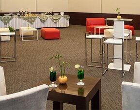 Elegant event lounge with cocktail tables, comfortable seating and flexible function space at NH Collection Mexico City Airport T2.
