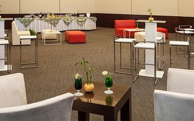 Elegant event lounge with cocktail tables, comfortable seating and flexible function space at NH Collection Mexico City Airport T2.