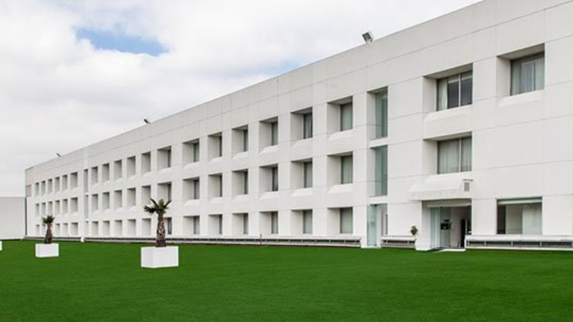 Exterior view of NH Collection Mexico City Airport T2 featuring contemporary architecture, landscaped grounds and convenient airport location.