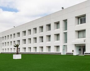 Exterior view of NH Collection Mexico City Airport T2 featuring contemporary architecture, landscaped grounds and convenient airport location.