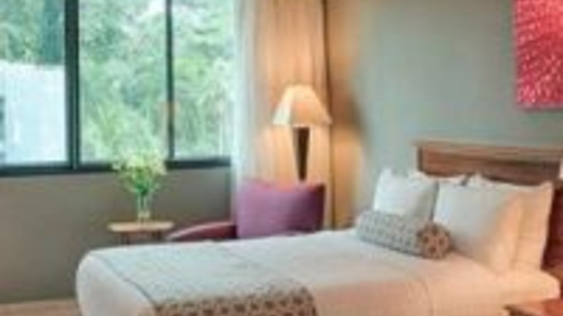 Comfortable guest room with two double beds, large window and modern amenities at Crowne Plaza Panama.