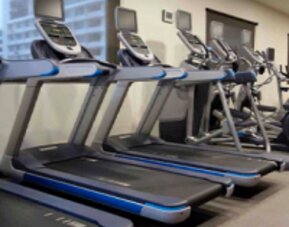 Fully equipped fitness center with treadmills and modern cardio equipment at Crowne Plaza Panama.