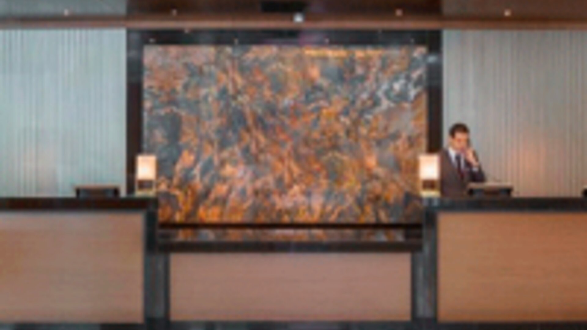 Contemporary hotel reception desk with professional front desk service and elegant lobby design at Crowne Plaza Panama.