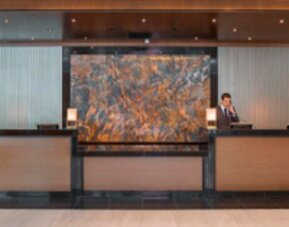Contemporary hotel reception desk with professional front desk service and elegant lobby design at Crowne Plaza Panama.
