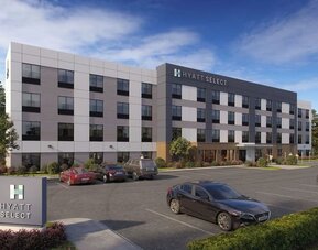 Exterior view of Hyatt Select Philadelphia Airport showcasing the contemporary hotel building, landscaped grounds and guest parking.