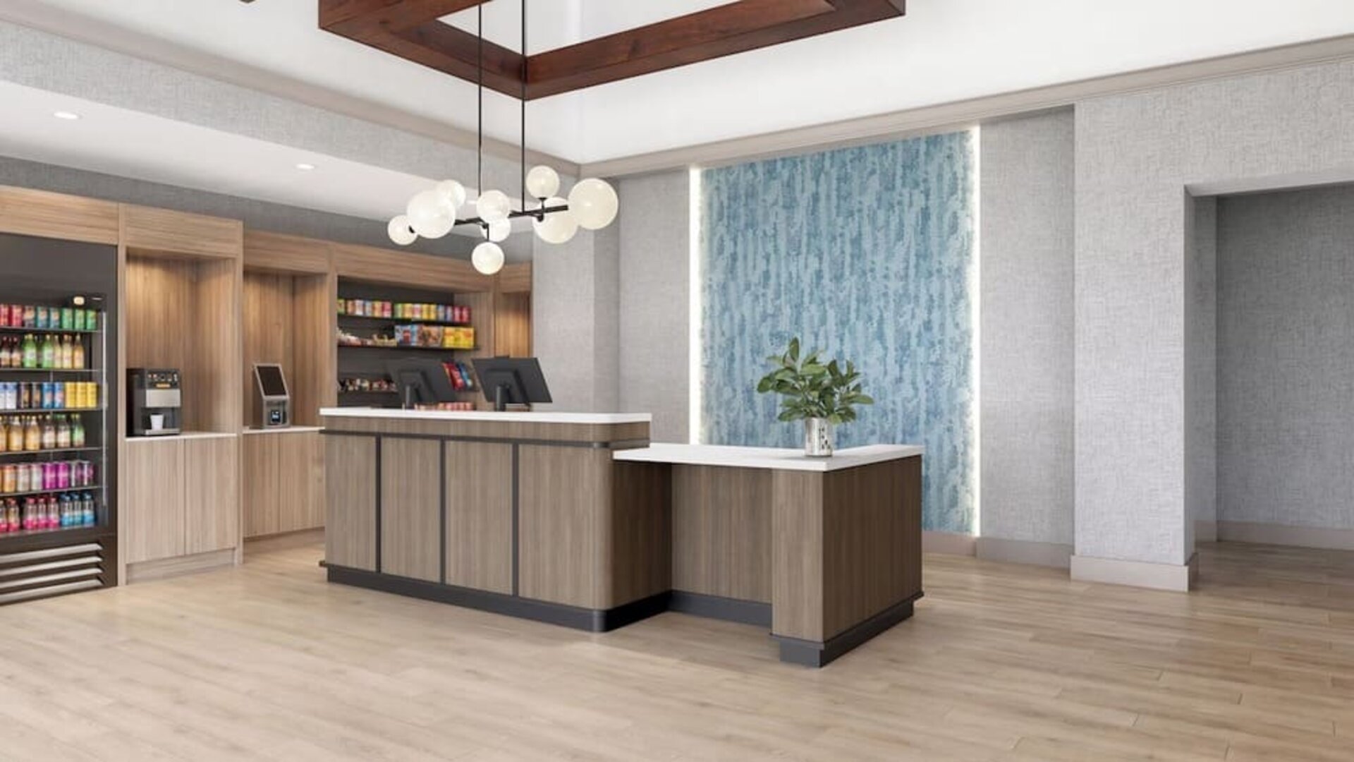 Hotel reception area featuring a modern front desk, snack market and welcoming lobby at Hyatt Select Philadelphia Airport.