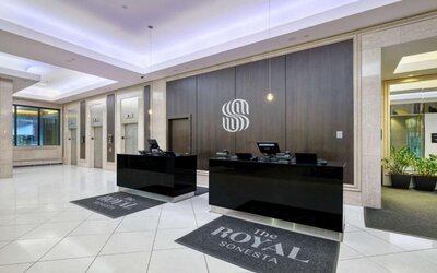 Elegant hotel lobby with a modern reception desk, polished floors and contemporary décor at Royal Sonesta Minneapolis.