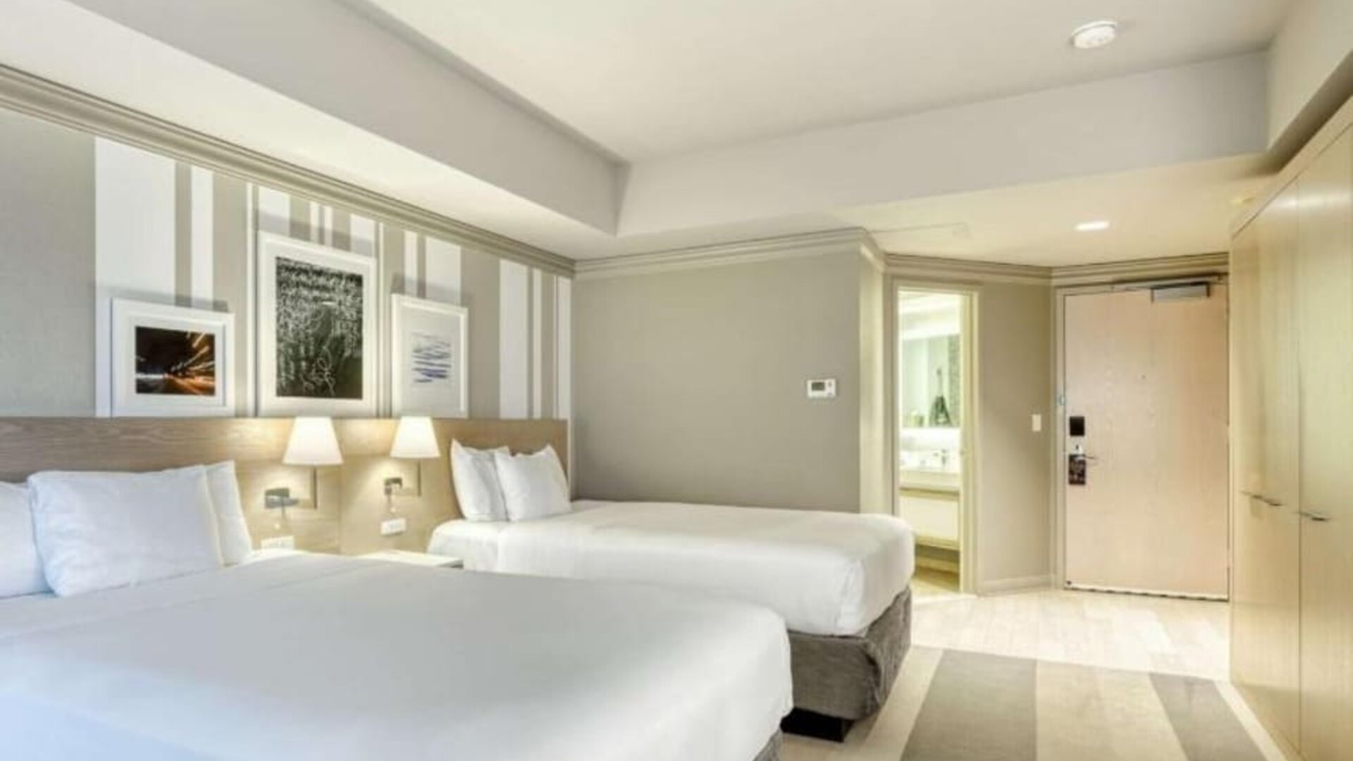 Bright guest room featuring two queen beds, contemporary décor and a spacious layout at Royal Sonesta Minneapolis.