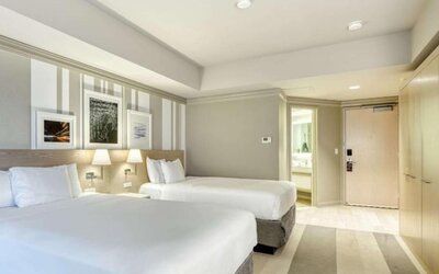 Bright guest room featuring two queen beds, contemporary décor and a spacious layout at Royal Sonesta Minneapolis.