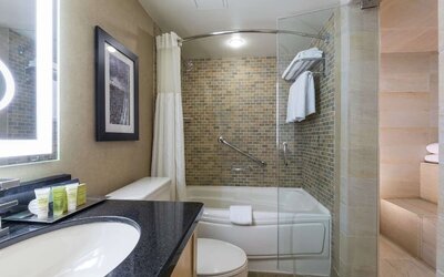 Guest bathroom with tub, sauna and toiletries at Hilton Whistler Resort & Spa.