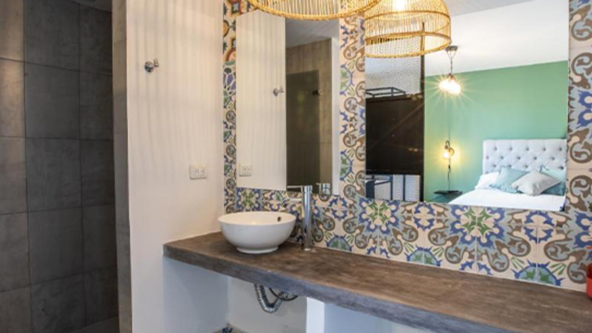 Bathroom at 103 Wonderful House featuring a vessel sink, walk-in shower and colorful patterned tile accents.
