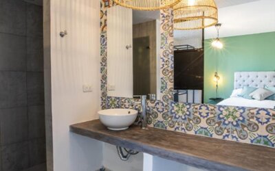 Bathroom at 103 Wonderful House featuring a vessel sink, walk-in shower and colorful patterned tile accents.