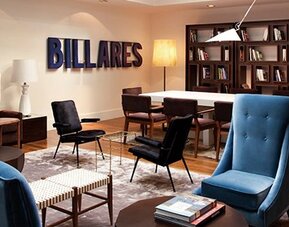 Lounge and meeting area at Hotel Pulitzer Buenos Aires featuring comfortable seating, bookshelves and a communal table.